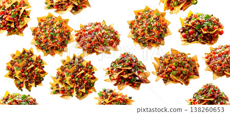 Assorted nachos loaded with fresh ingredients shown isolated on white background representing street food concept Assorted nachos loaded with fresh ingredients shown isolated on white background representing street food concept 138260653
