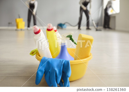 Janitorial cleaning crew and bucket of supplies on polished floor indoors Janitorial cleaning crew and bucket of supplies on polished floor indoors 138261360
