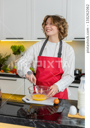 Young woman whisking eggs for omelet in home kitchen for healthy diet breakfast cooking routine plan Young woman whisking eggs for omelet in home kitchen for healthy diet breakfast cooking routine plan 138262062