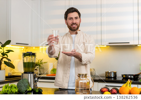 Middle-aged man drinking water in kitchen for hydration wellness and healthy diet at home lifestyle Middle-aged man drinking water in kitchen for hydration wellness and healthy diet at home lifestyle 138262536