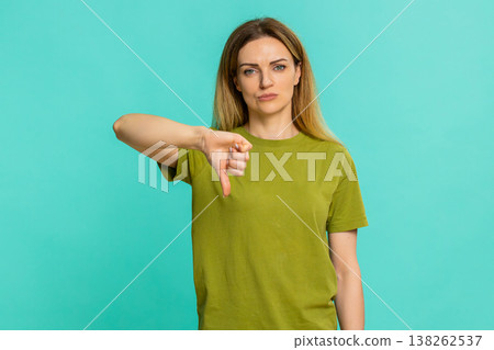 Adult woman showing thumbs down with serious face expressing dislike disapproval negative feedback Adult woman showing thumbs down with serious face expressing dislike disapproval negative feedback 138262537