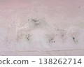 Peeling pink wall with cracked plaster and rough texture, weathered surface revealing gray cement underneath, abstract grunge background. 138262714