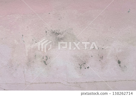Peeling pink wall with cracked plaster and rough texture, weathered surface revealing gray cement underneath, abstract grunge background. Peeling pink wall with cracked plaster and rough texture, weathered surface revealing gray cement underneath, abstract grunge background. 138262714