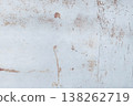 Rusty metal surface with peeling paint, scratches, and oxidized textures, abstract industrial background with warm brown and pale blue tones. 138262719