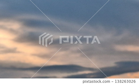Abstract blurred sunset sky background with soft orange and blue pastel clouds 138263026