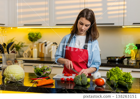 Young woman making fresh vegetable salad in home kitchen for healthy diet weight loss nutrition plan Young woman making fresh vegetable salad in home kitchen for healthy diet weight loss nutrition plan 138263151
