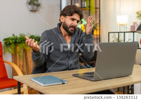 Indian man faces laptop app crash virus glitch error does facepalm annoyed frustrated reaction upset 138263312