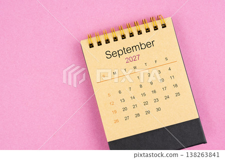 Brown desk calendar for September 2027 on pink color background. Brown desk calendar for September 2027 on pink color background. 138263841