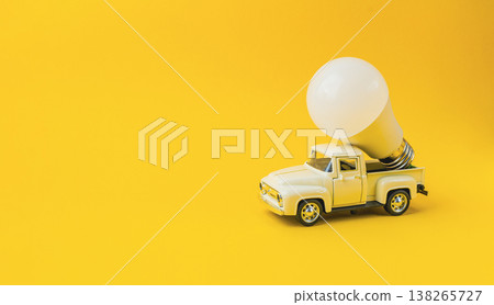 Vintage toy truck with a large light bulb attached, symbolizing innovation and sustainability in ecology, set against a vibrant yellow background, representing creativity and environmental awareness 138265727