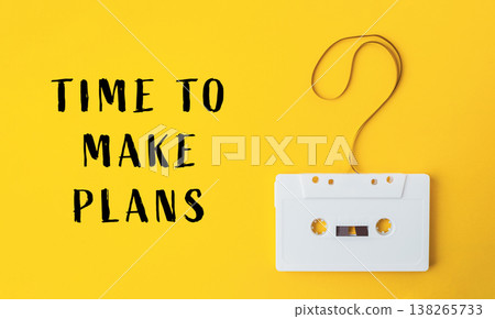 Vintage cassette tape on vibrant yellow background, symbolizing nostalgia and creativity, with handwritten text encouraging planning and organization for future endeavors Vintage cassette tape on vibrant yellow background, symbolizing nostalgia and creativity, with handwritten text encouraging planning and organization for future endeavors 138265733