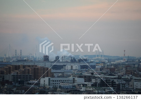 A landscape featuring the sunrise sky, cityscapes, a factory with a smoke-emitting chimney, a bridge, and mountains. A landscape featuring the sunrise sky, cityscapes, a factory with a smoke-emitting chimney, a bridge, and mountains. 138266137
