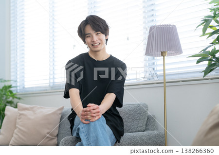 Young man relaxing by the window Young man relaxing by the window 138266360