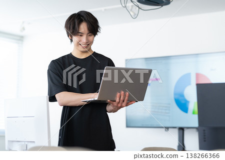A young male engineer working on his office computer. A young male engineer working on his office computer. 138266366