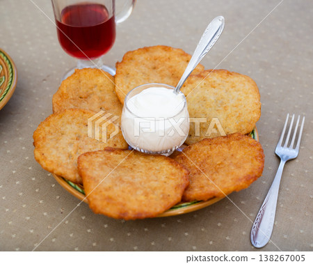 Crispy Potato Pancakes with Cream Topping Crispy Potato Pancakes with Cream Topping 138267005