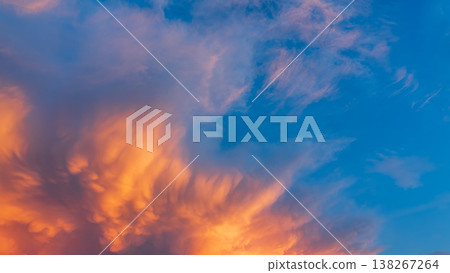 Sunset clouds that resemble sandstorms drift by at summer twilight. Sunset clouds that resemble sandstorms drift by at summer twilight. 138267264