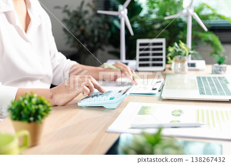 Sustainable finance budgeting supports ESG reporting and net-zero planning analyst calculates costs beside renewable energy models and performance charts with copy space. sustainable, finance, ESG Sustainable finance budgeting supports ESG reporting and net-zero planning analyst calculates costs beside renewable energy models and performance charts with copy space. sustainable, finance, ESG 138267432