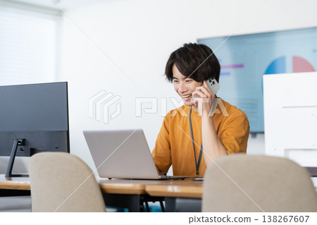 A young male engineer working on his office computer. A young male engineer working on his office computer. 138267607