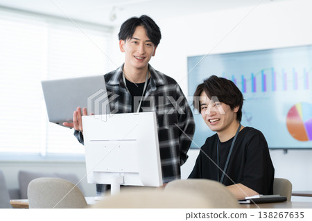 A young male engineer working on his office computer. 138267635