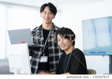 A young male engineer working on his office computer. 138267637