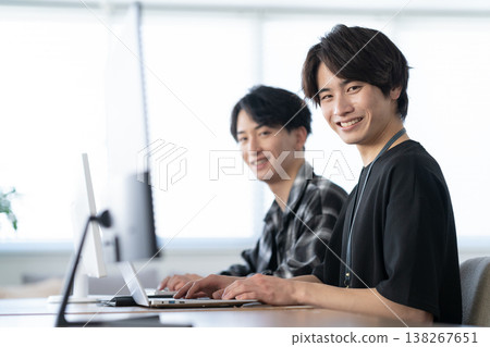 A young male engineer working on his office computer. A young male engineer working on his office computer. 138267651
