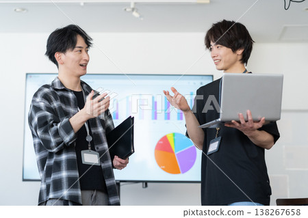 A young male engineer working on his office computer. 138267658