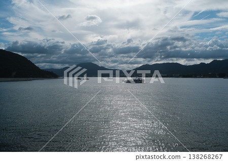 Serene Coastal Waters with Distant Mountains 138268267