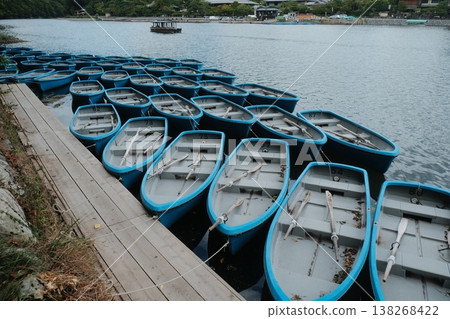 Rows of Blue Boats on Calm Water Rows of Blue Boats on Calm Water 138268422