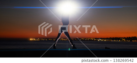 Woman silhouette radiating light at sunset horizon Woman silhouette radiating light at sunset horizon 138269542