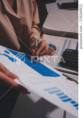 Above table with finance papers, graphs and big data during teamwork meeting with accounting or marketing team discussing budget, strategy or growth development. Closeup of SEO team doing research Above table with finance papers, graphs and big data during teamwork meeting with accounting or marketing team discussing budget, strategy or growth development. Closeup of SEO team doing research 138269912