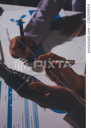 Above table with finance papers, graphs and big data during teamwork meeting with accounting or marketing team discussing budget, strategy or growth development. Closeup of SEO team doing research 138269914