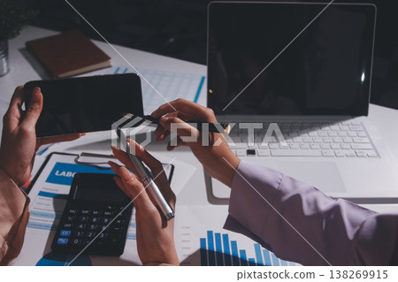Above table with finance papers, graphs and big data during teamwork meeting with accounting or marketing team discussing budget, strategy or growth development. Closeup of SEO team doing research 138269915