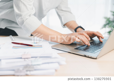 Business professional using calculator and pen reviewing financial report charts on office desk, budgeting and accounting analysis for planning, audit and fintech management workflow. financial report Business professional using calculator and pen reviewing financial report charts on office desk, budgeting and accounting analysis for planning, audit and fintech management workflow. financial report 138270301