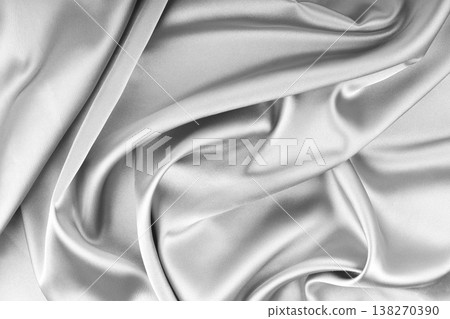 Crumpled, wrinkled white colored glossy silk satin texture. Shiny fabric cloth with wave folds Crumpled, wrinkled white colored glossy silk satin texture. Shiny fabric cloth with wave folds 138270390