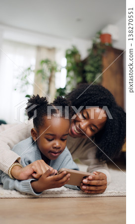 Mother and daughter bonding with a smartphone 138270551