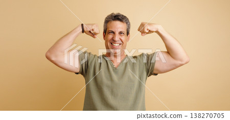 Man flexing muscles showing strength and confidence Man flexing muscles showing strength and confidence 138270705