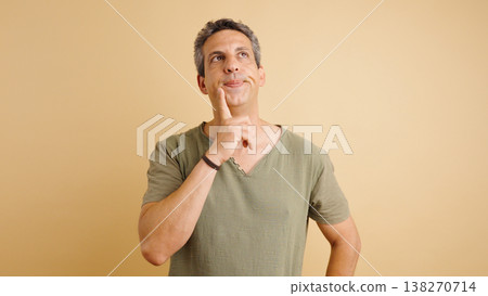 Mature man pondering looking up creating a new idea Mature man pondering looking up creating a new idea 138270714