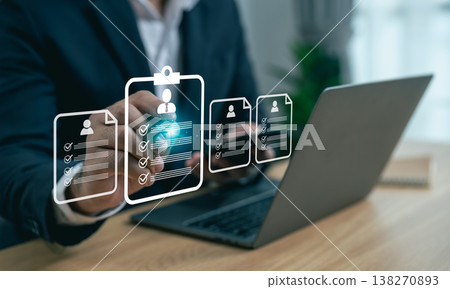 Professional Checking and Approval Process with Digital Icons of Resumes and Checklists on Laptop in Modern Office Setting Professional Checking and Approval Process with Digital Icons of Resumes and Checklists on Laptop in Modern Office Setting 138270893