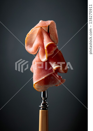 Raw fresh smoked pork bacon slices on a fork. 138270911