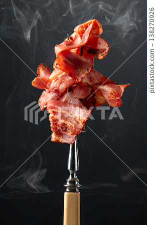 Roasted bacon on a fork. Roasted bacon on a fork. 138270926