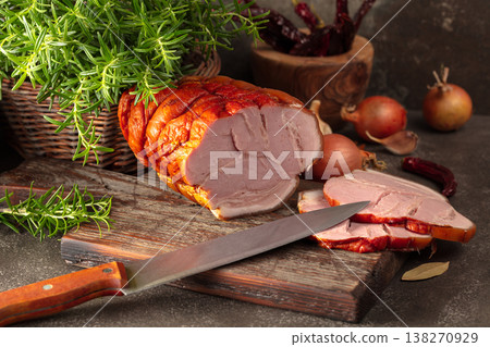 Smoked pork ham on a kitchen table. Smoked pork ham on a kitchen table. 138270929