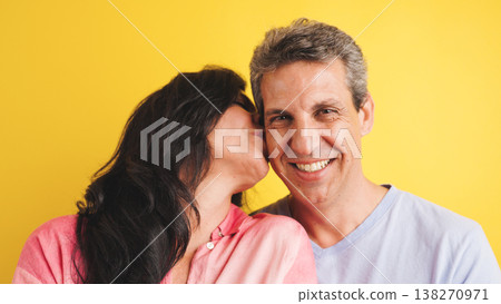 Loving middle aged couple showing affection with a kiss Loving middle aged couple showing affection with a kiss 138270971