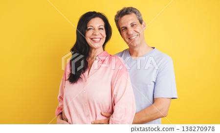 Happy smiling couple embracing on yellow background 138270978