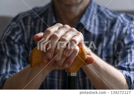 Middle age caucasian man hands holds cane closeup Middle age caucasian man hands holds cane closeup 138272127