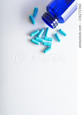 Health care background of pills and bottle on white surface flat lay 138272368