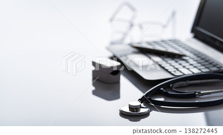 Healthcare background of stethoscope pulse oximeter laptop glasses and pen on table with copy-space Healthcare background of stethoscope pulse oximeter laptop glasses and pen on table with copy-space 138272445