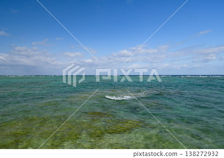 A view of the crystal-clear, emerald-green sea from Kaamiji Beach Park in Urasoe City, Okinawa, with tiny whitecaps. 138272932
