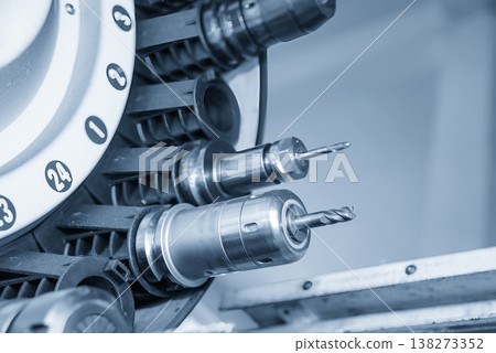 Close-up of a flat nose end mill installed in a high-precision hydraulic tool holder within a CNC machine tool magazine. Close-up of a flat nose end mill installed in a high-precision hydraulic tool holder within a CNC machine tool magazine. 138273352