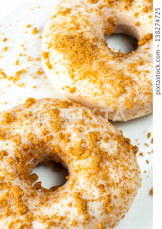 Sweet pastry donuts decorated with caramel sprinkles close up. Sweet pastry donuts decorated with caramel sprinkles close up. 138274725