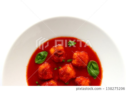 Tomato soup with meatballs against a white background, viewed from directly above. Tomato soup with meatballs against a white background, viewed from directly above. 138275206