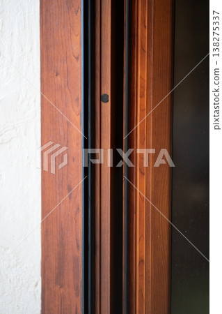 Wooden door frame with intricate moldings and trim details, forming a strong architectural design element, highlighting craftsmanship and traditional joinery Wooden door frame with intricate moldings and trim details, forming a strong architectural design element, highlighting craftsmanship and traditional joinery 138275337